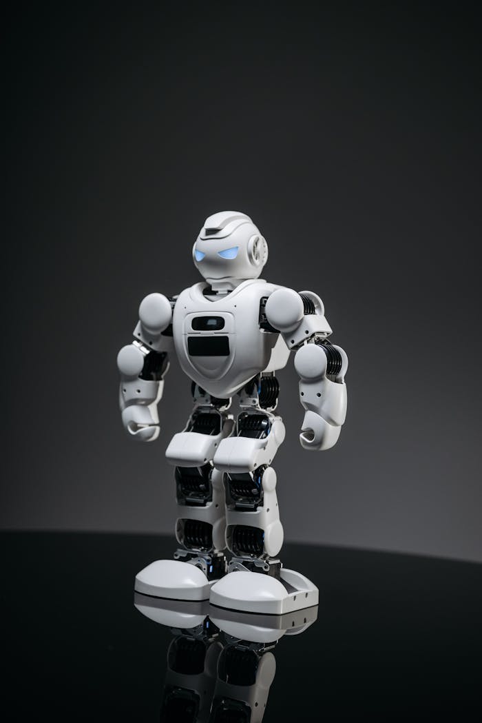 A modern white robot with glowing blue eyes standing in a dimly lit indoor setting.